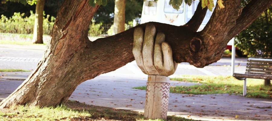 hand statue supporting tree